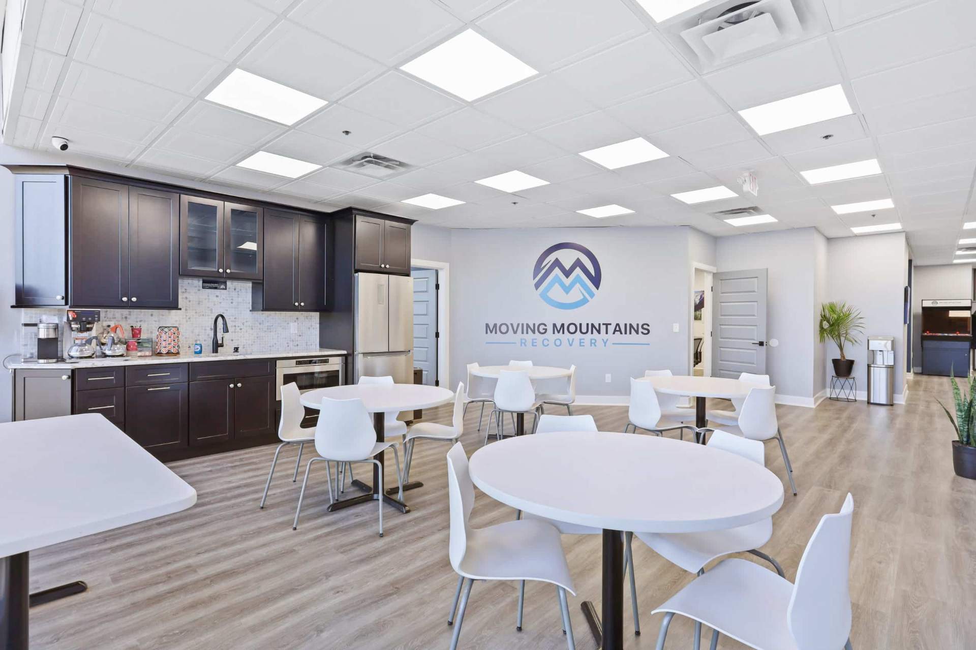 Dining room and kitchen with Moving Mountains logo