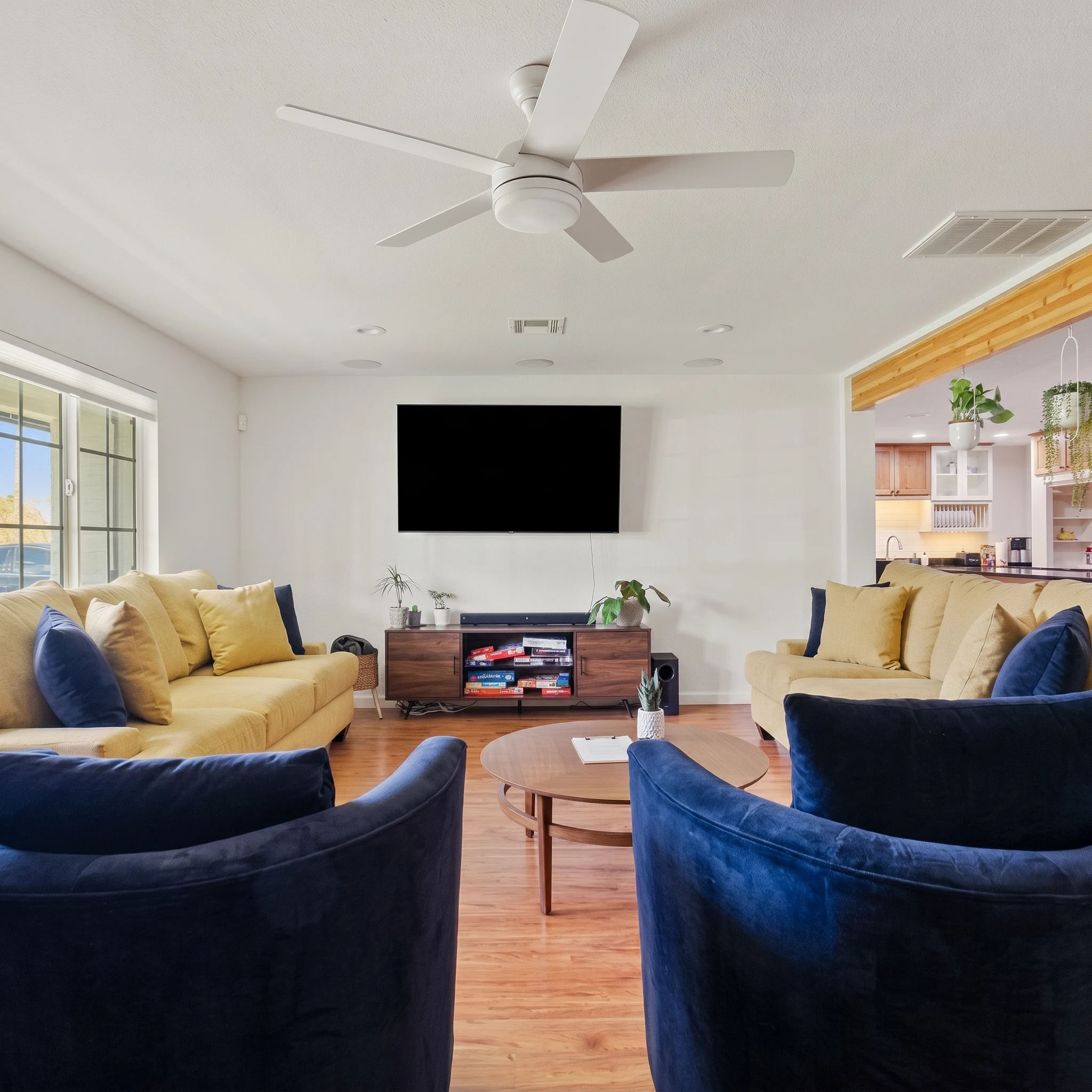 Residential living room with yellow sofas and navy armchairs