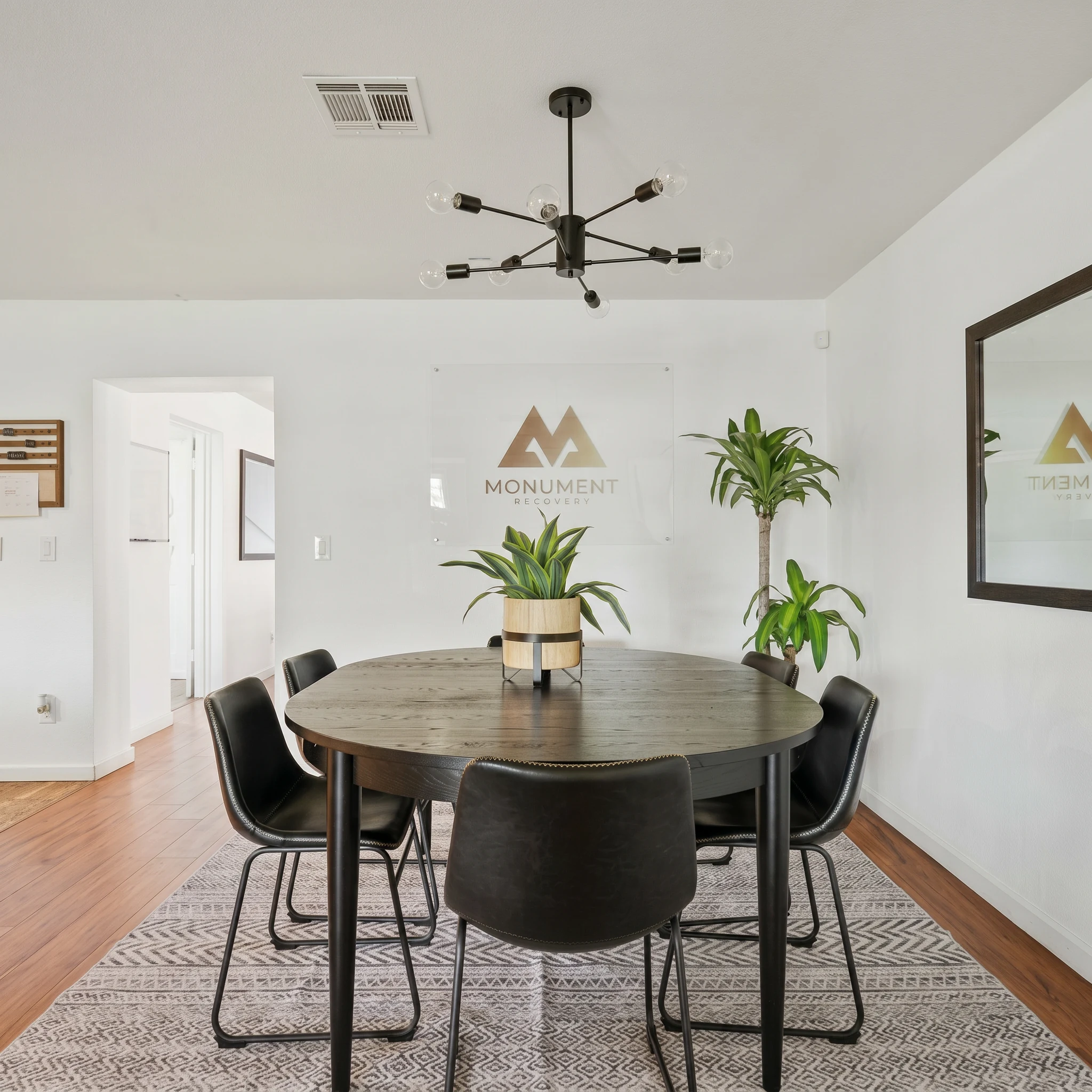 Residential dining nook with Monument Recovery logo wall art