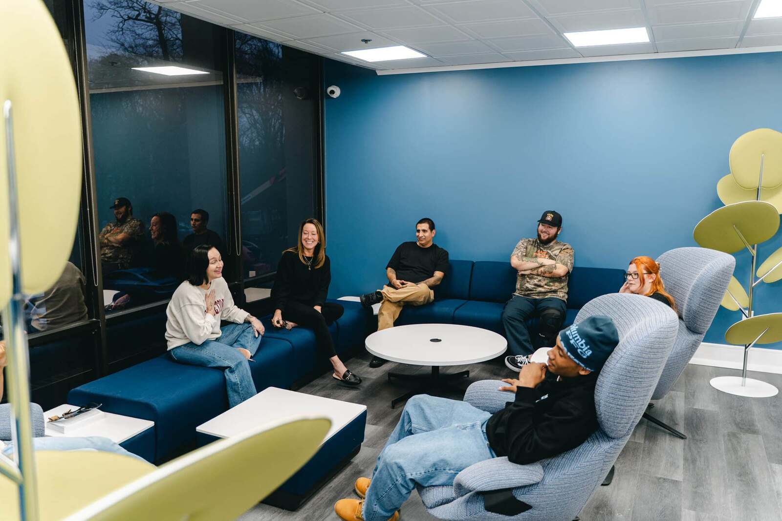 Clinician and clients in a group session in the Moving Mountains lounge