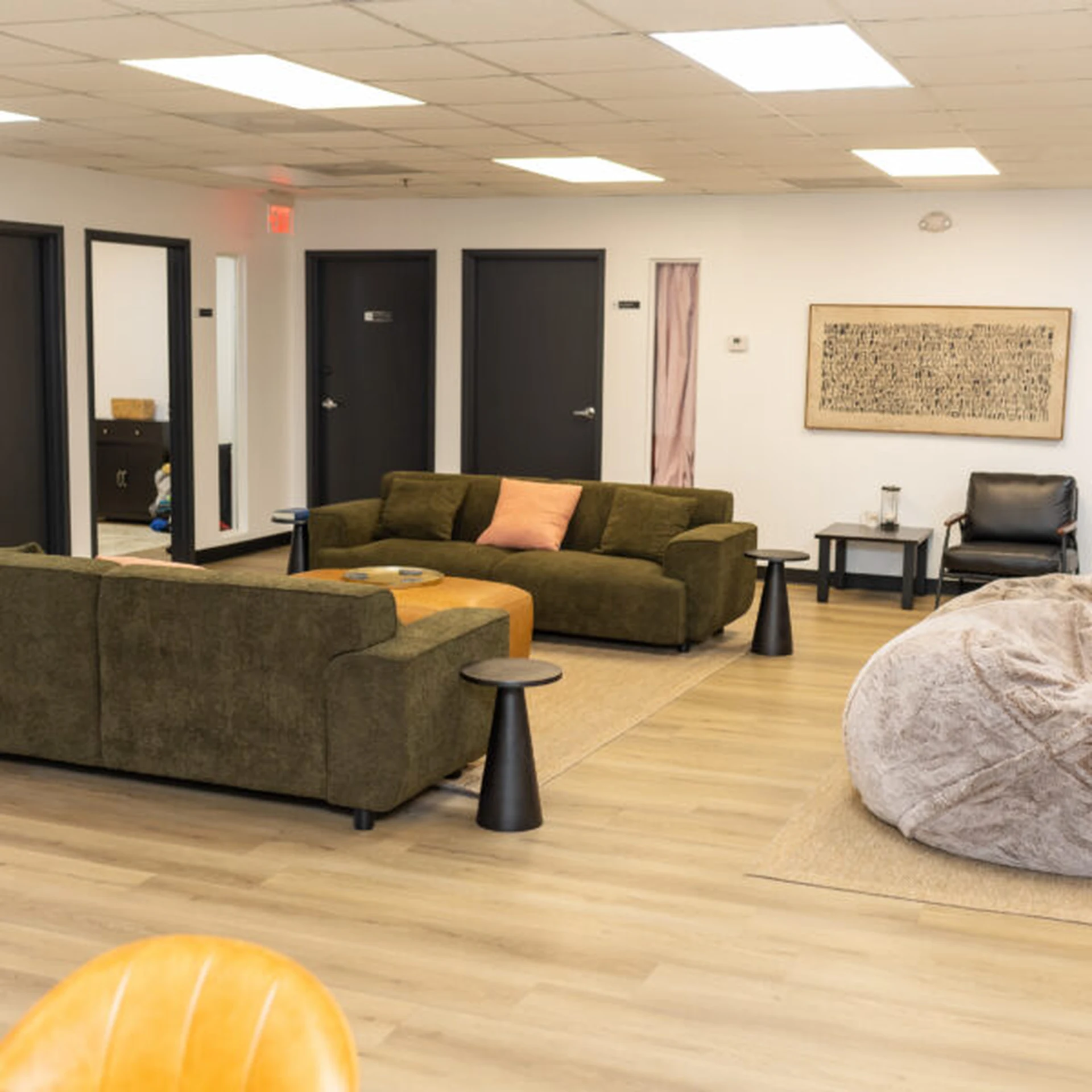 Common area with green sofas and bean bag seating